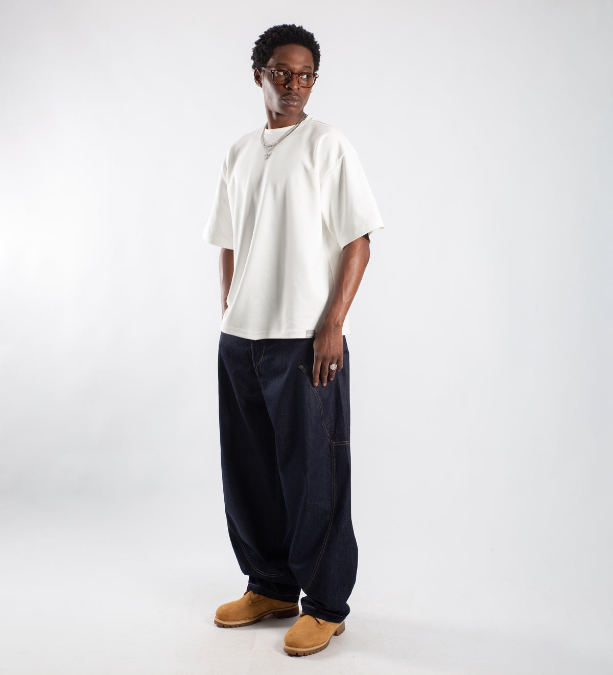 Off-white 320 GSM heavyweight boxy T-shirt holding a structured silhouette over wide denim